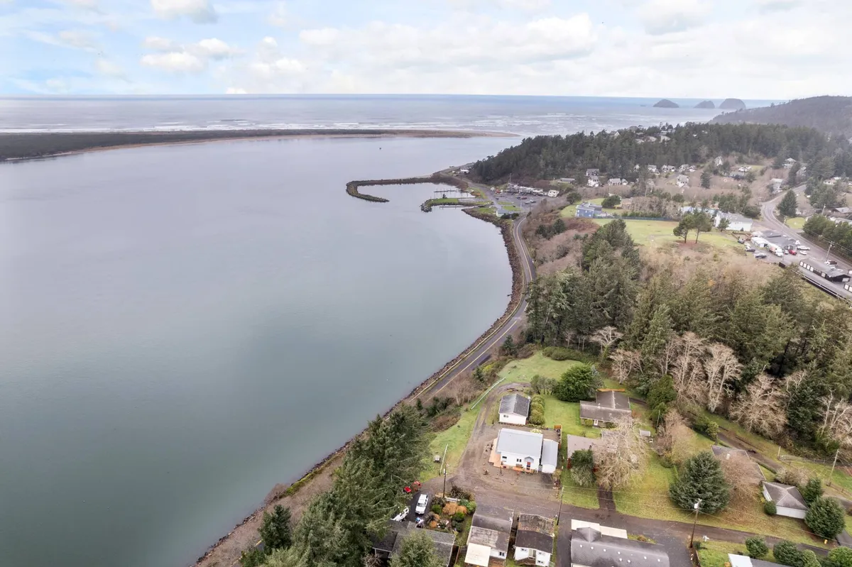 Sweeping views of the river, coastline, and wooded surroundings create a sense of wild beauty. The expansive landscape hints at the natural wonders and ever-changing tableau visible from the property, reinforcing the unique setting for wildlife enthusiasts and photographers.